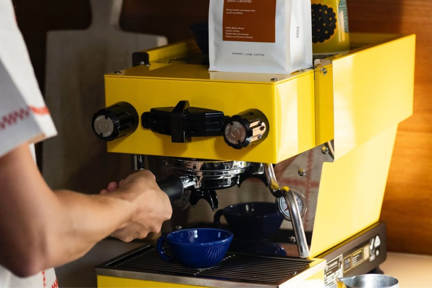 a person works on a coffee machine